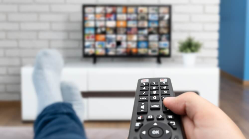 pointing a TV remote at a smart TV