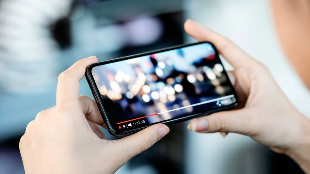 video being played on phone being held in hands