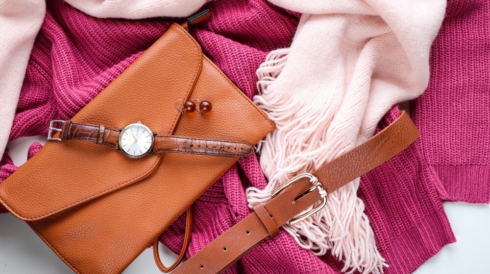 brown handbag on pink sweater